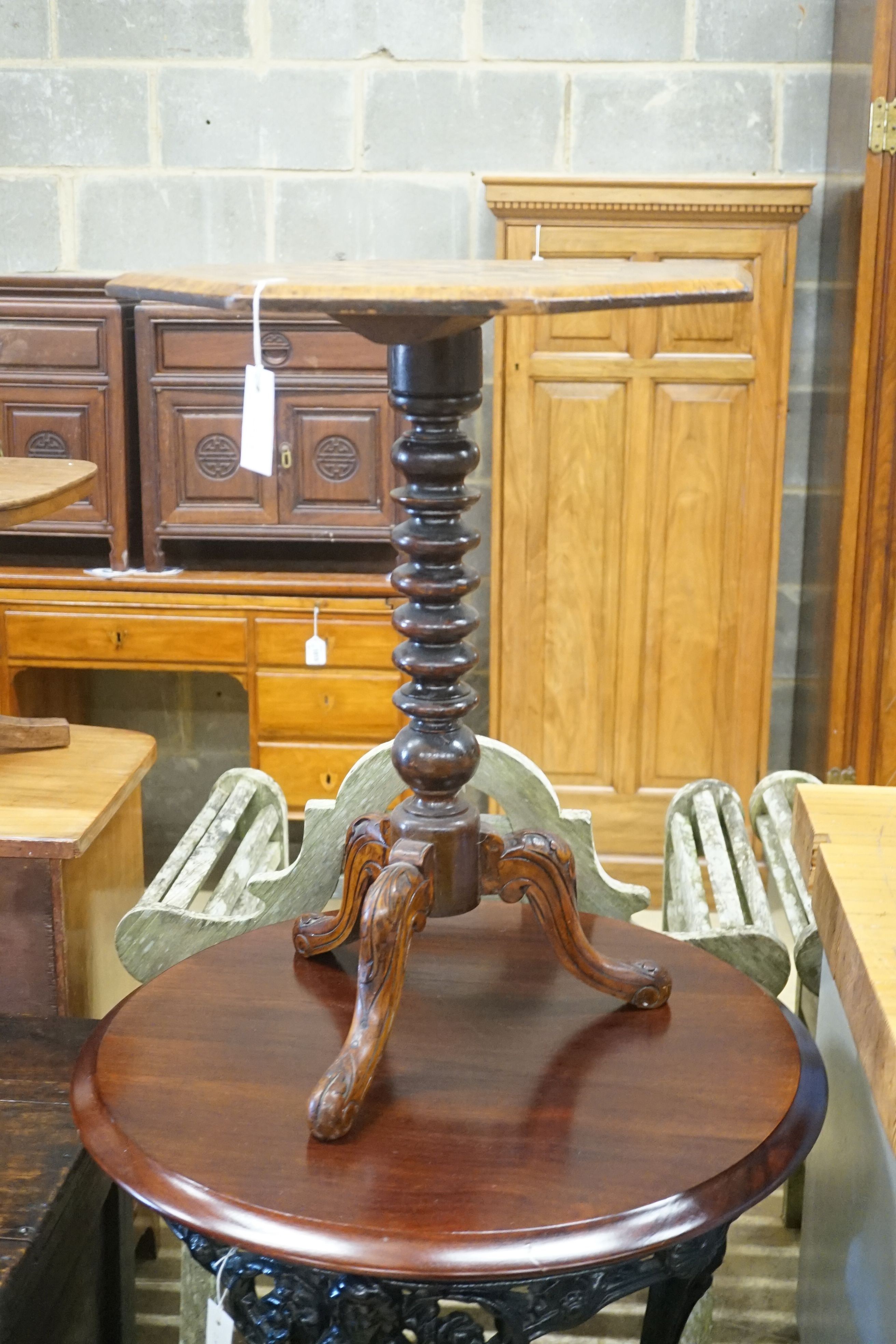 A Victorian octagonal walnut tripod games table, width 50cm height 67cm